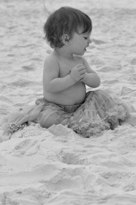 baby in green tutu smiling in bw with high contrast