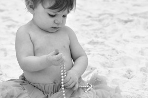 baby in green tutu with pearls bw