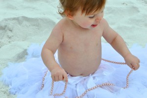 baby in tutu in sand