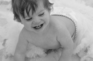 baby in tutu with smile bw